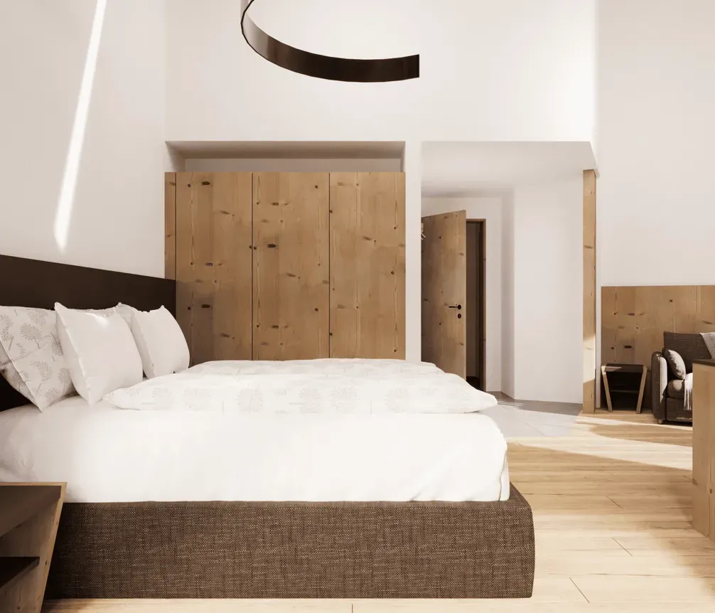 Modern hotel room with a large bed, wooden accents, and cozy seating area. Bright, airy space with minimalist decor and natural light.