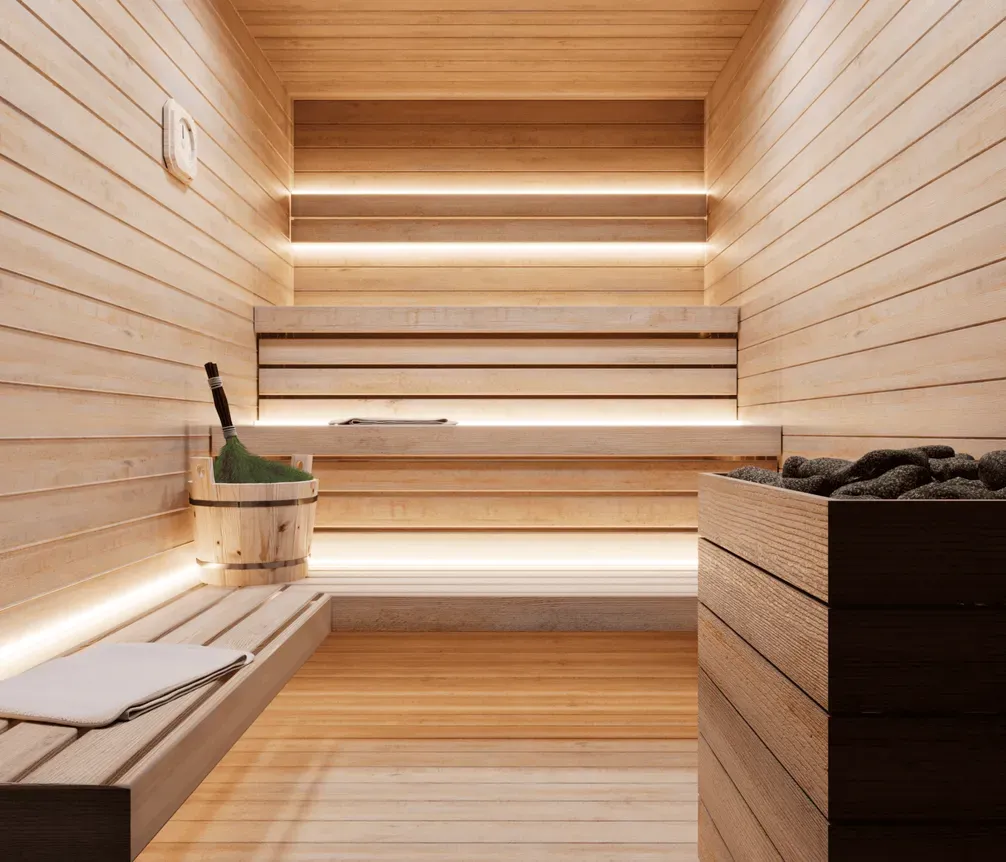 Wooden sauna with warm lighting in the private spa.